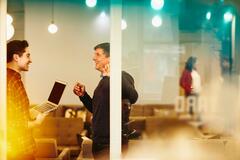 two men talking in the office