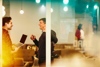 two men talking in the office