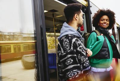 Man and woman getting out of a bus.